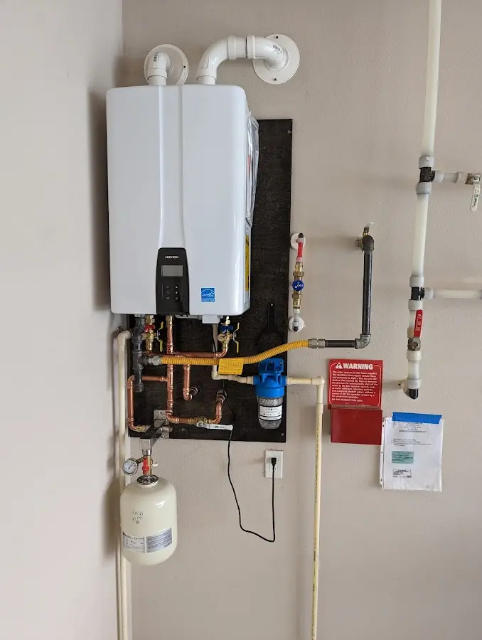 Professional plumber installing copper piping in a Perkasie home